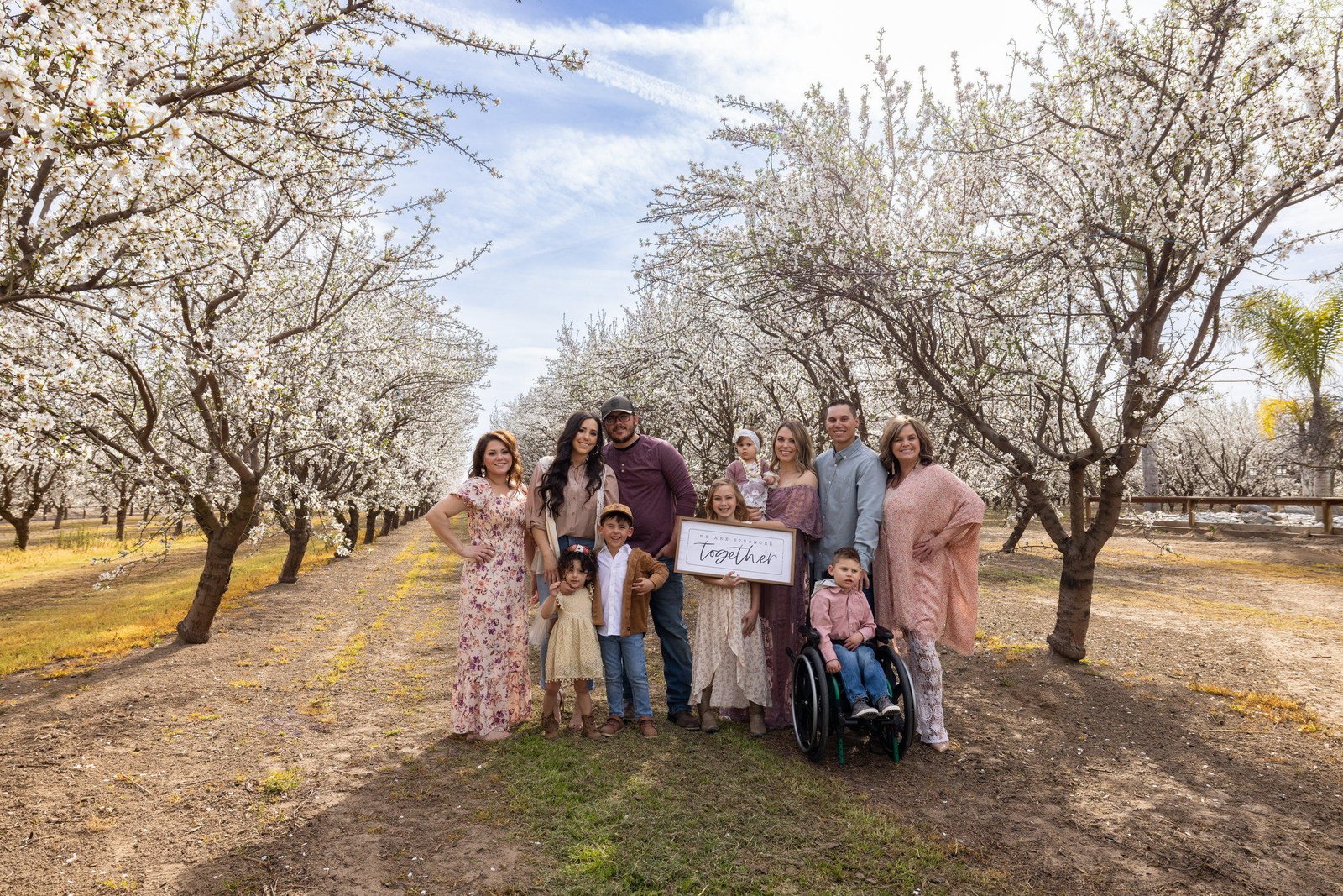 Extended family gathered among almond blossoms