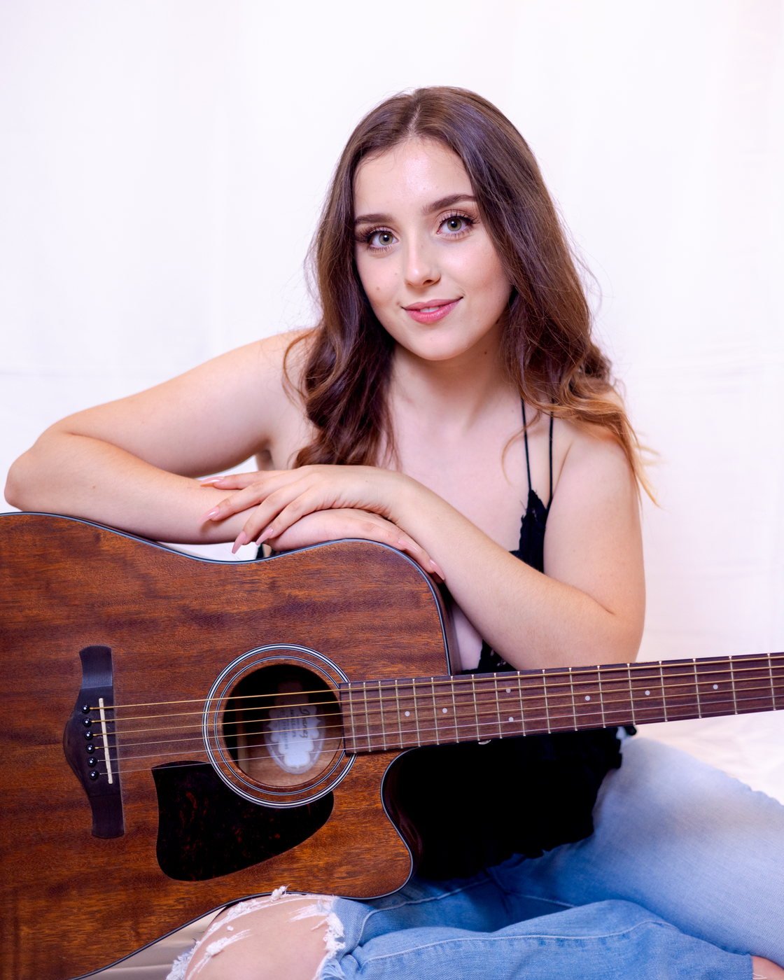 Senior with her guitar in the studio