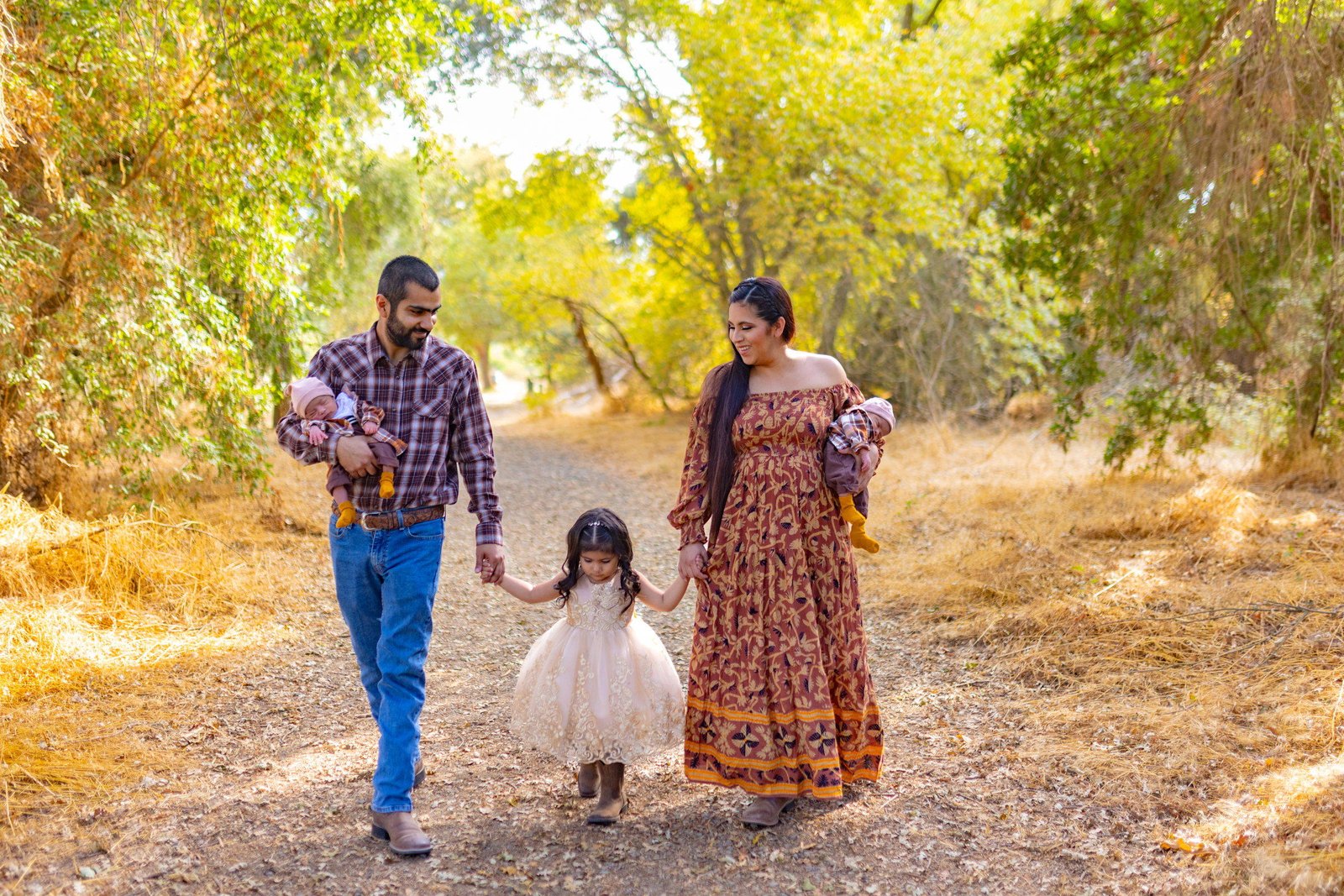 Family walking a tree-lined path in the Central Valley